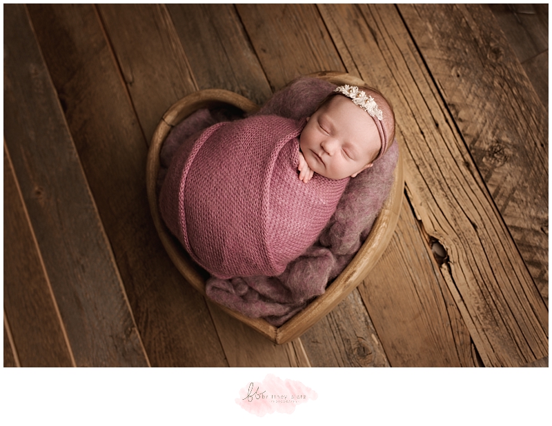 Calgary newborn photographer baby girl in wooden heart bowl